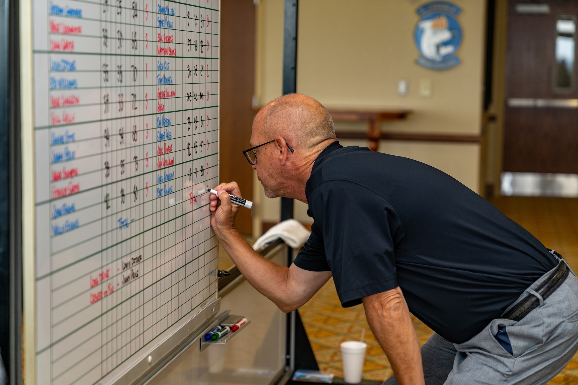 Luke Rooney, golf center director, writes down the final scores during the annual Don Wylie Golf Tournament at Keesler Air Force Base, Mississippi, Sept. 16, 2023.