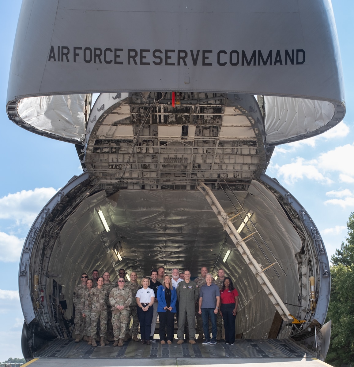 AFRC civic leaders and Airmen pose for a group photo in a C-5 Galaxy