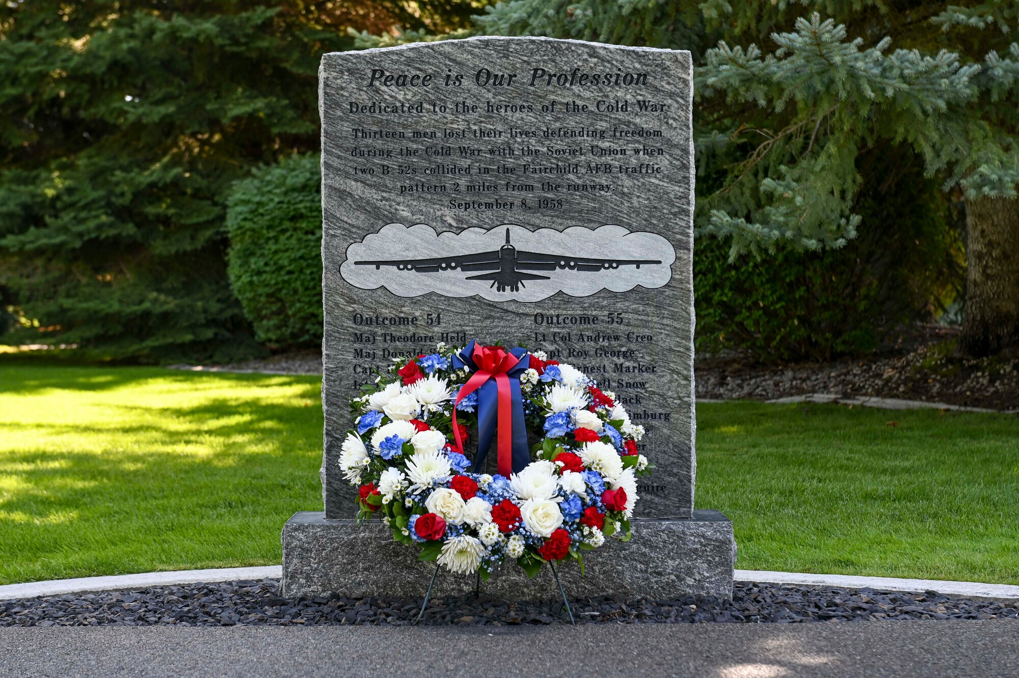 A plaque with a red, white, and blue wreath placed in front.