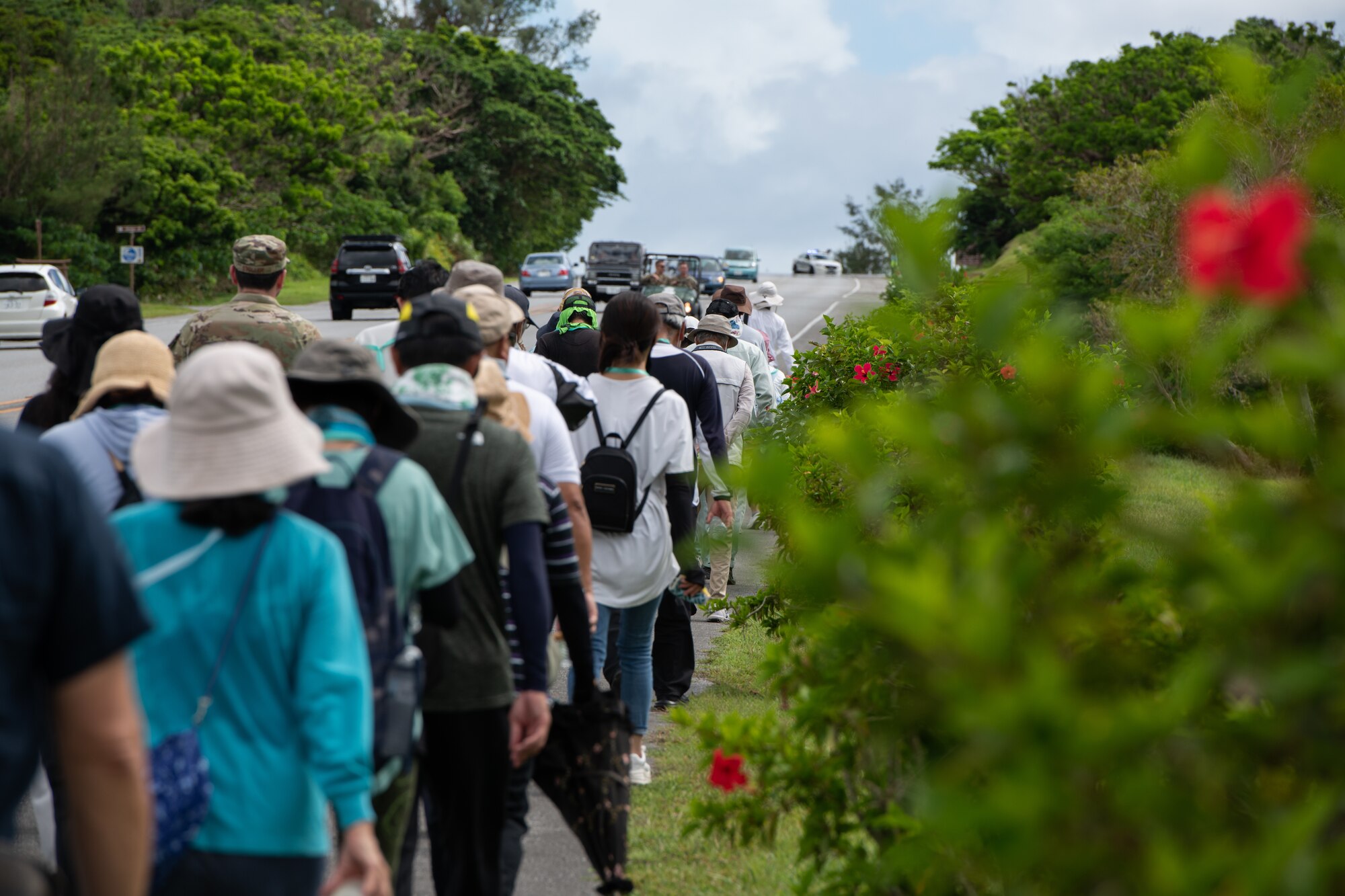 Participants walk up a hill.