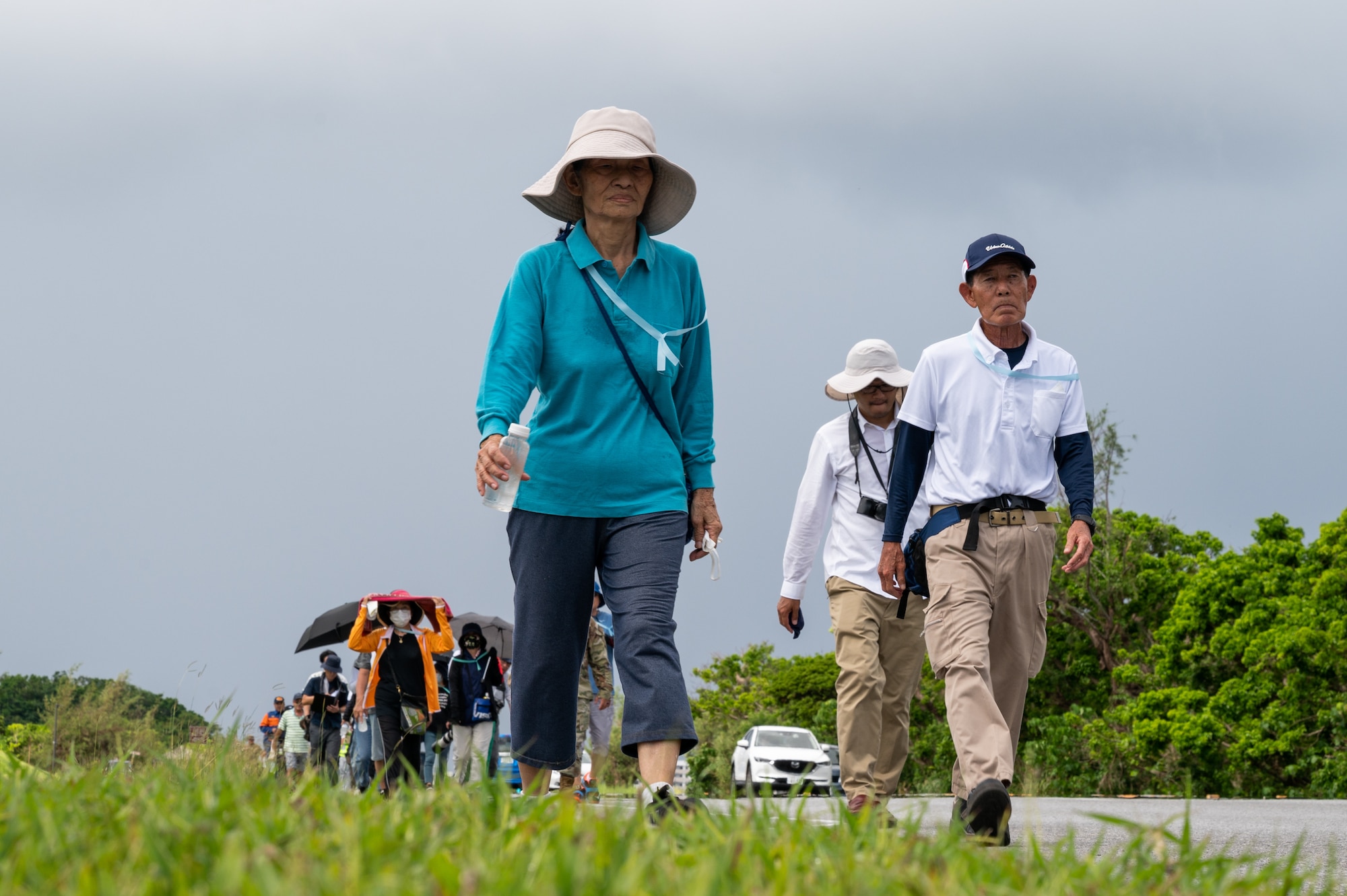 Participants walk up a hill.