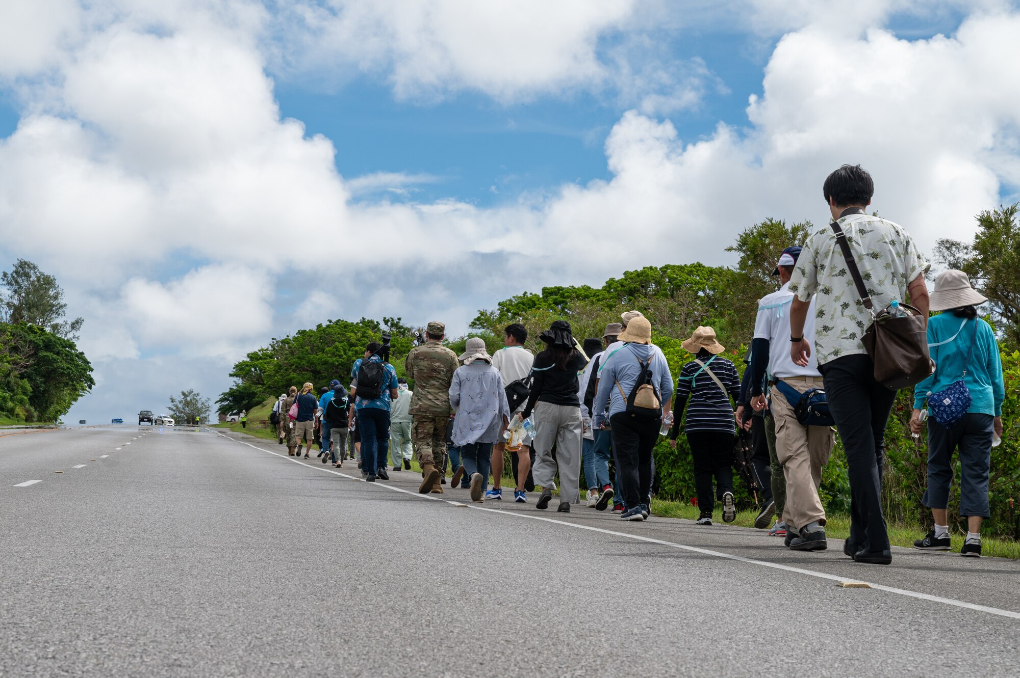 Participants walk up a hill.