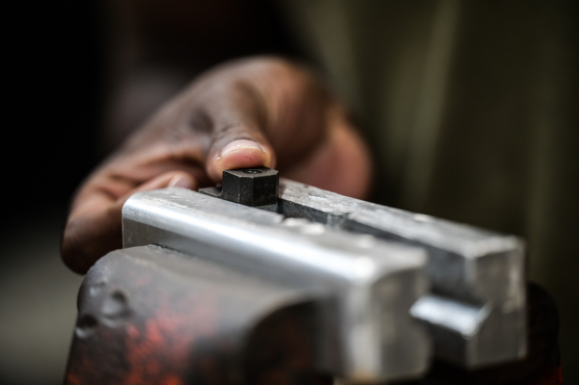 Airman 1st Class Nyamsi Ael, 15th Maintenance Squadron aircraft metals technology journeyman, examines the threads on a wind-shield level for a C-17 Globemaster III at Joint Base Pearl Harbor-Hickam, Hawaii, July 31, 2023. The 15th MXS metals technology Airmen are trained to manipulate metal with a variety of machinery to increase the longevity of the transportation airframes stationed at Hickam. (U.S. Air Force photo by Staff Sgt. Alan Ricker)