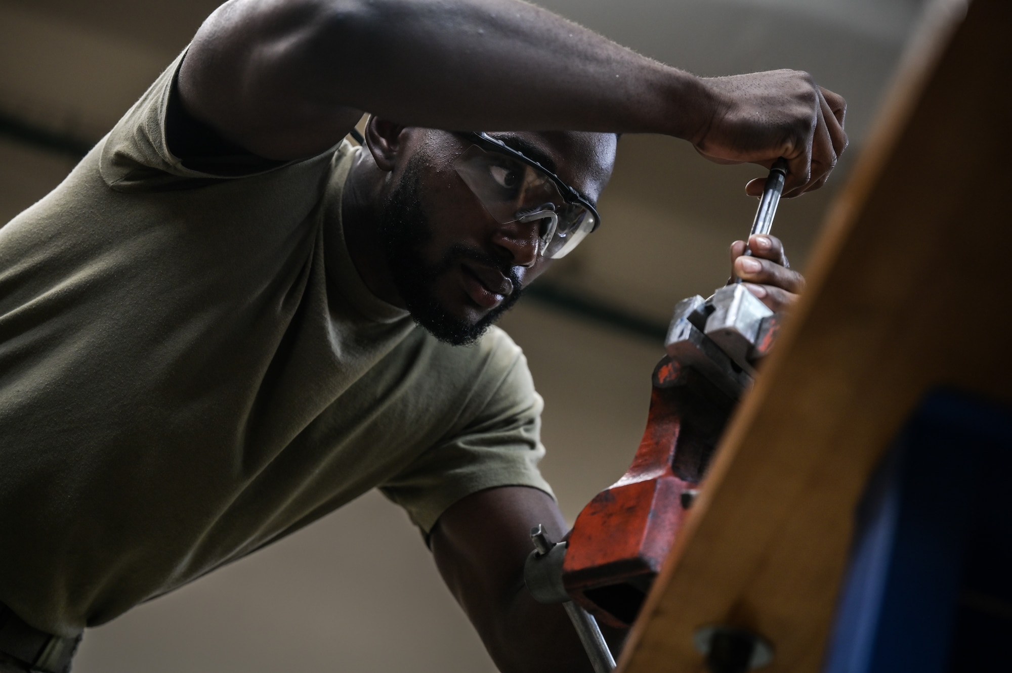Airman 1st Class Nyamsi Ael, 15th Maintenance Squadron aircraft metals technology journeyman, utilizes a thread repair tool on wind-shield level for a C-17 Globemaster III at Joint Base Pearl Harbor-Hickam, Hawaii, July 31, 2023. The 15th MXS metals technology Airmen are trained to manipulate metal with a variety of machinery to increase the longevity of the transportation airframes stationed at Hickam. (U.S. Air Force photo by Staff Sgt. Alan Ricker)