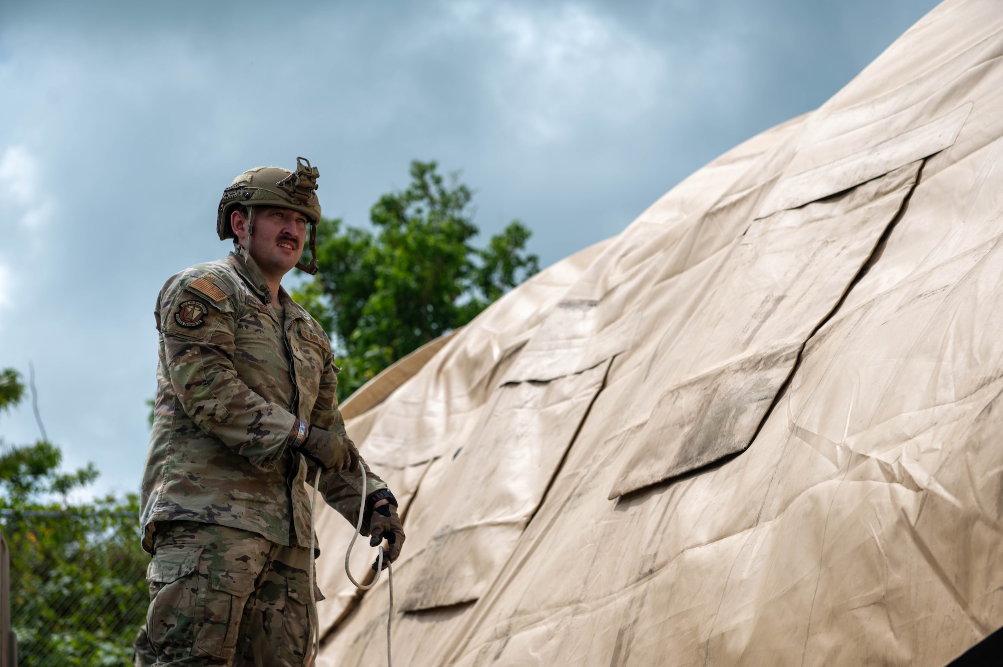A U.S. Air Force Airman, assigned to the 36th Civil Engineering Squadron, builds a tent during Prime Base Engineer Emergency Force training on Andersen Air Force Base, Guam, Sept. 19, 2023. Airmen assigned to the 36th CES participated in Prime Base Engineer Emergency Force to develop their core competencies on base and during deployment. (U.S. Air Force photo by Airman Allon Lapaix)