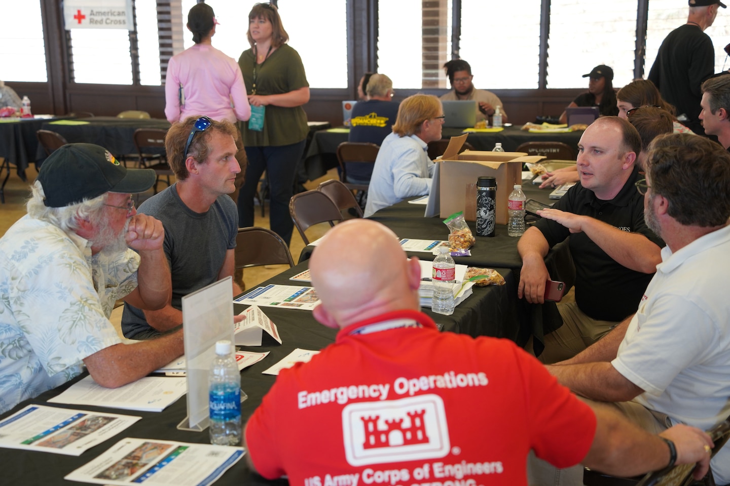 A group of people talk at a table