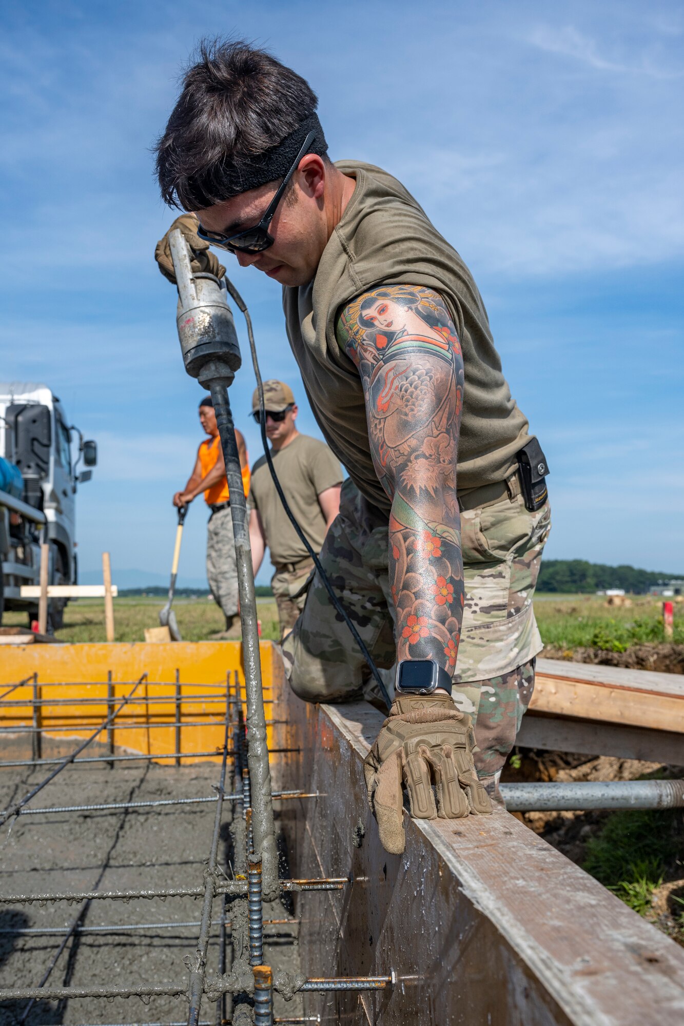 An Airman working with wet cement.