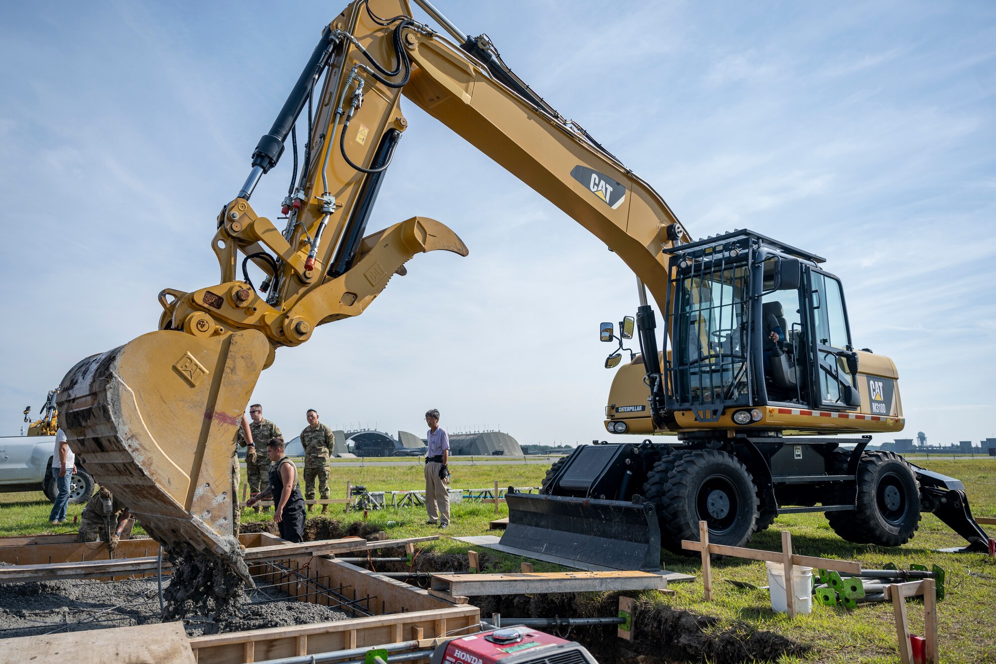 A Japanese man operating an excavator.
