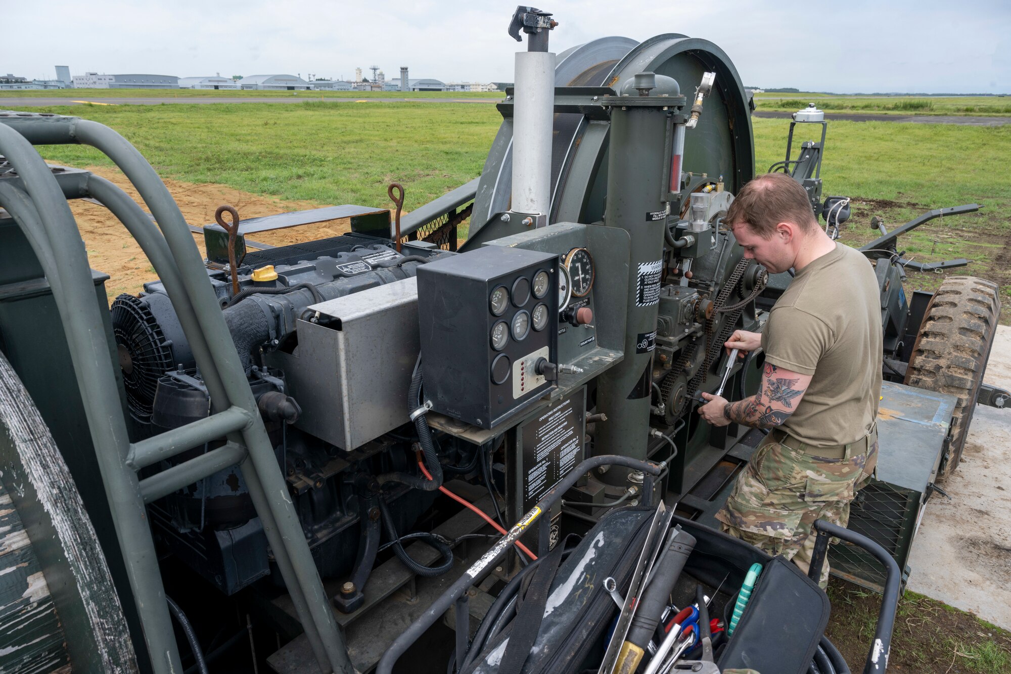 An Airman preforms maintenance on a machine.