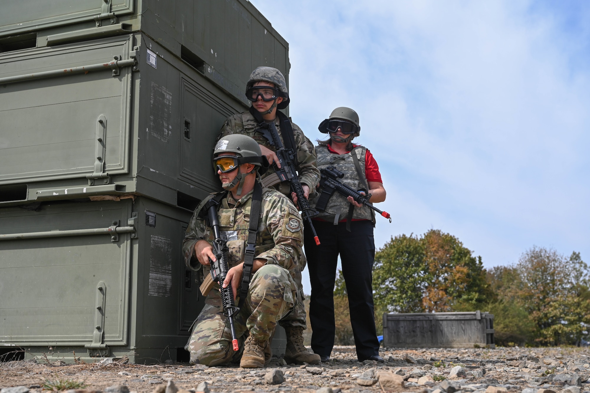 People in uniform hold weapons