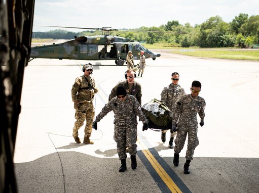 Photo of pararescuemen and jump masters from U.S. Air Force and Royal Brunei Air Force