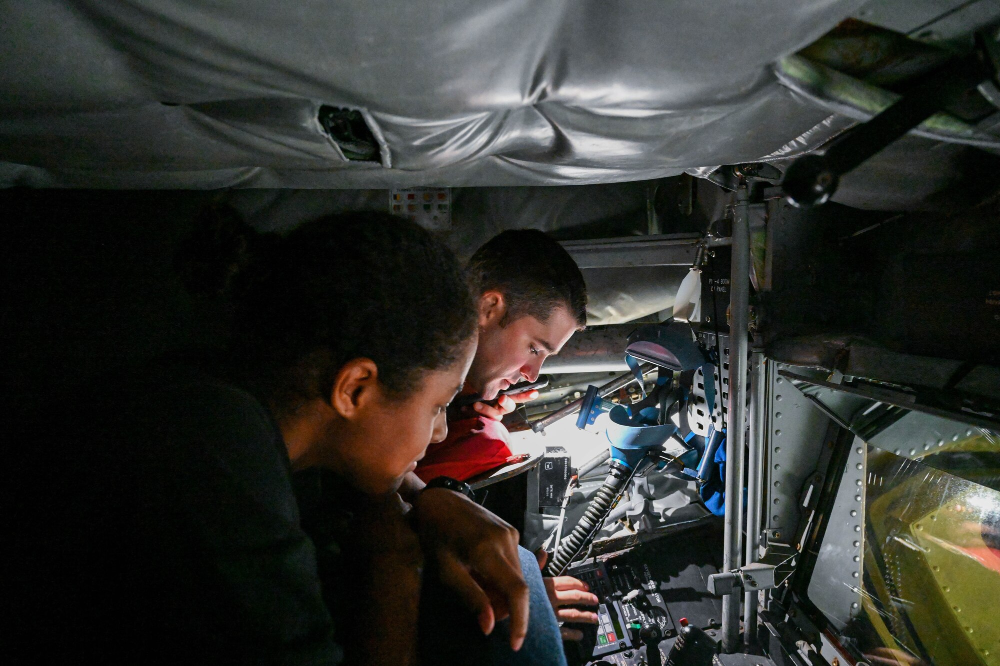 U.S. Air Force Capt. Matthew Miller, 54th Air Refueling Squadron KC-135 instructor pilot, shows the boom pod of a KC-135 Stratotanker to April Houston, Air Force ROTC Det. 845 cadet, at Altus Air Force Base, Oklahoma, Sept. 14, 2023. The KC-135 has a fuel capacity of 200,000 pounds. (U.S. Air Force photo by Airman 1st Class Miyah Gray)