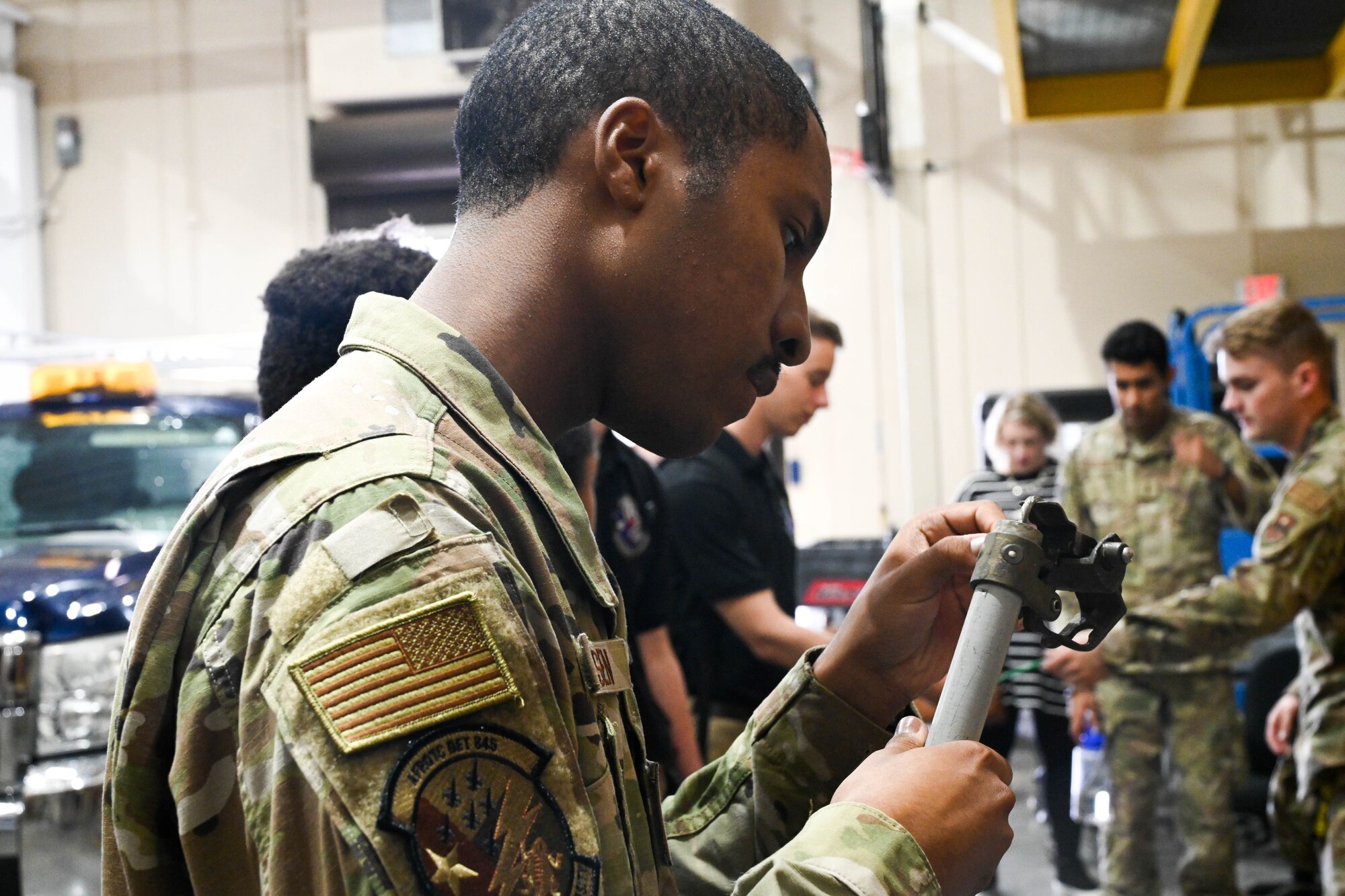 Derek Larson, Air Force ROTC Det. 845 cadet, inspects a fuse cutout during a tour on the 97th Civil Engineer Squadron at Altus Air Force Base, Oklahoma, Sept. 14, 2023. Fuse cutouts protect distribution transformers from current surges and overloads. (U.S. Air Force photo by Airman 1st Class Miyah Gray)