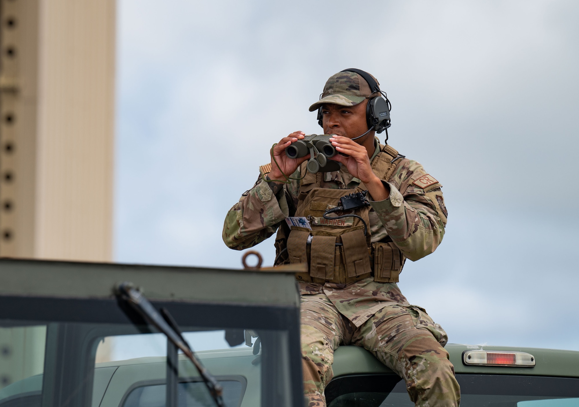 A U.S. Contingency Response Airman looks at the flightline on Anderson Air Force Base, Guam during Mobility Guardian 23 on July 11, 2023. Contingency Response Airmen are responsible for rapidly deploying personnel and quickly establishing airbases around the globe. This capability allows U.S. forces, Allies and partners to be agile and respond to real world needs whenever and wherever necessary. MG23 is a mobility exercise held across a 3,000-mile area intended to deepen interoperability with U.S. allies and partners, bolstering the collective ability to support a free and open Indo-Pacific area.