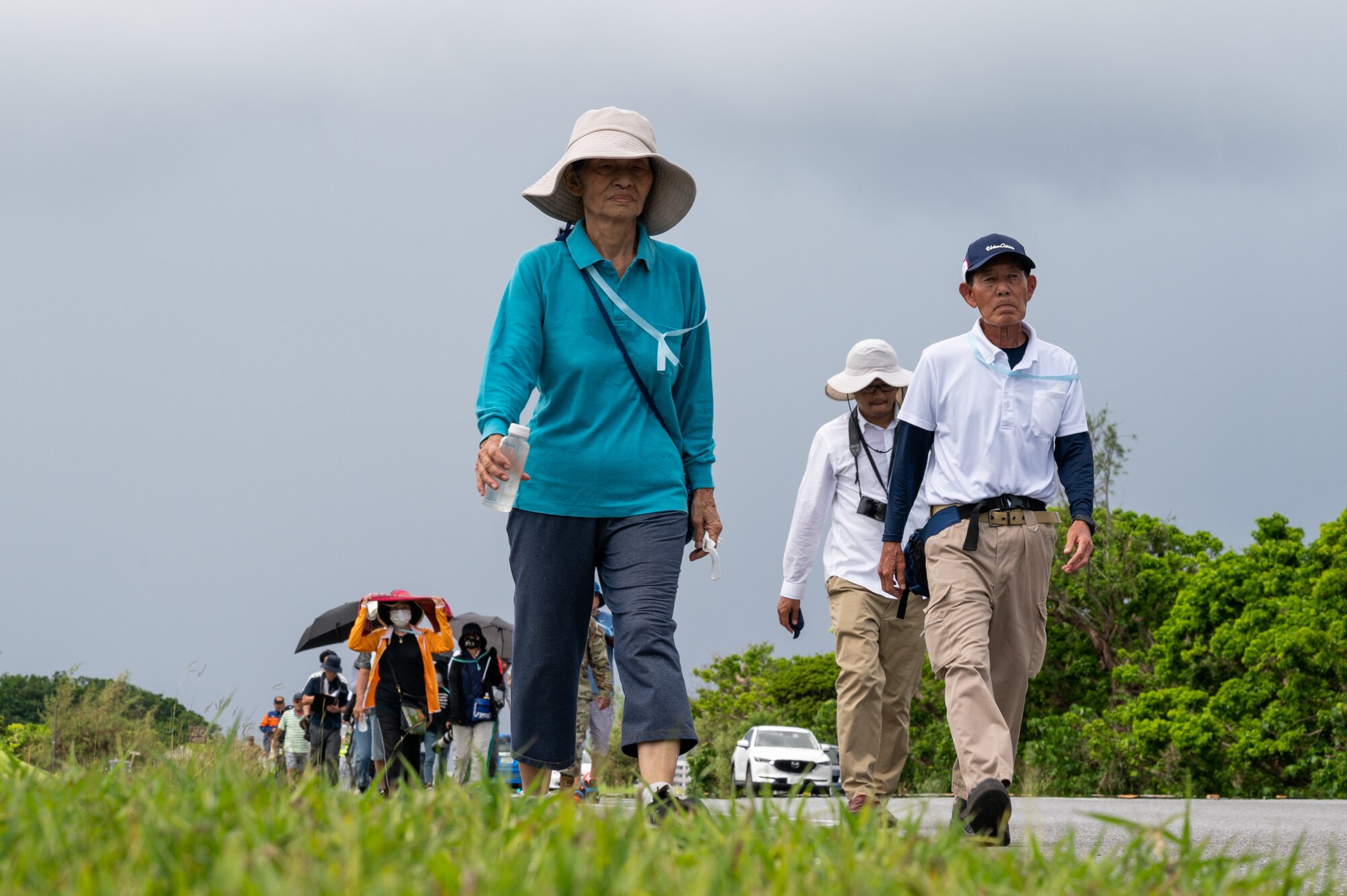 Participants walk up a hill.