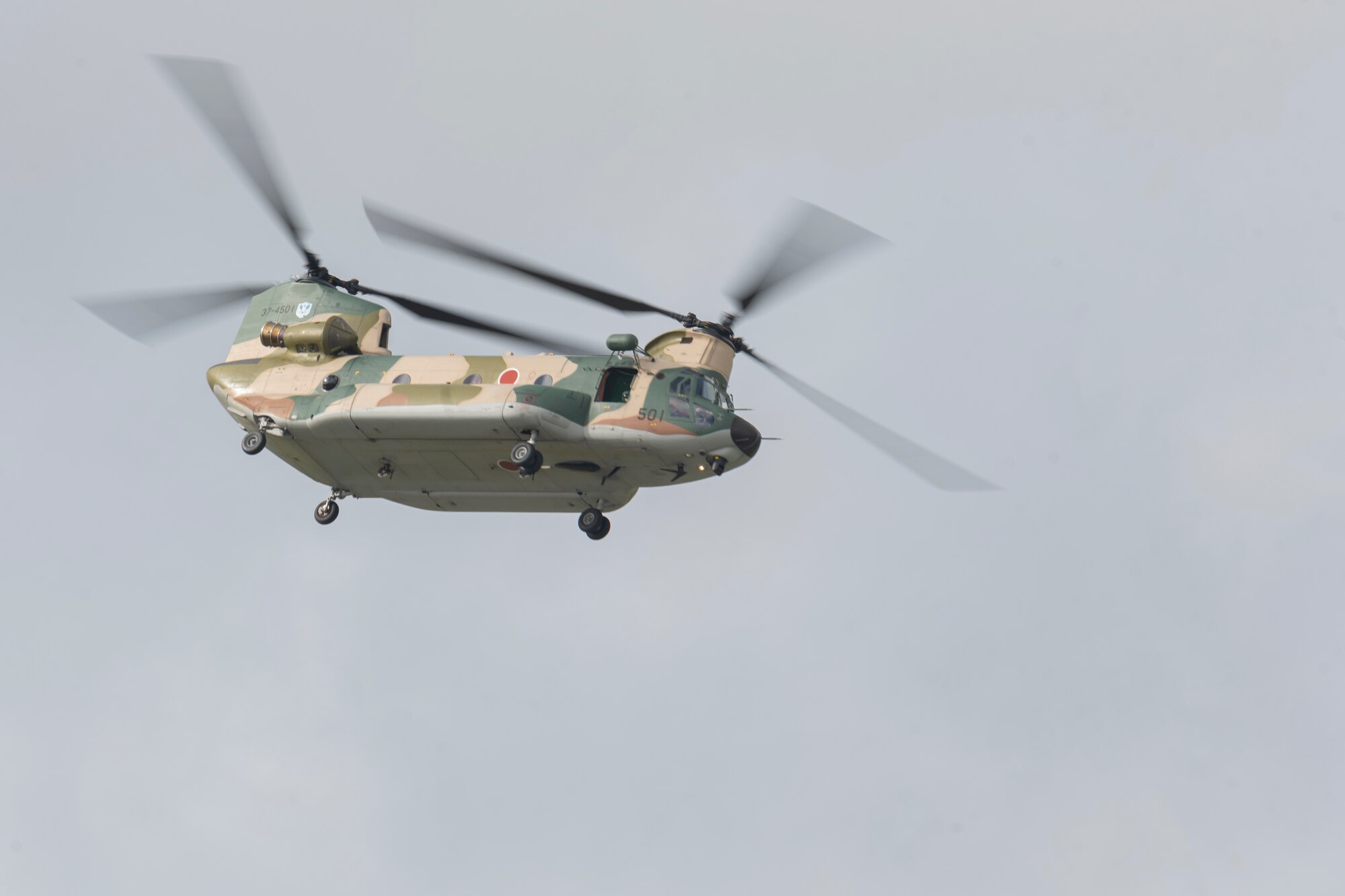 A helicopter flying through the sky a Misawa Air Fest 2023.