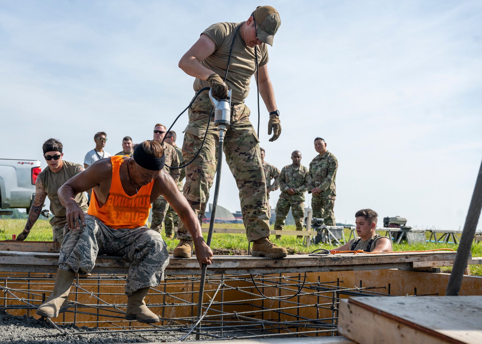Two men work together to set cement.