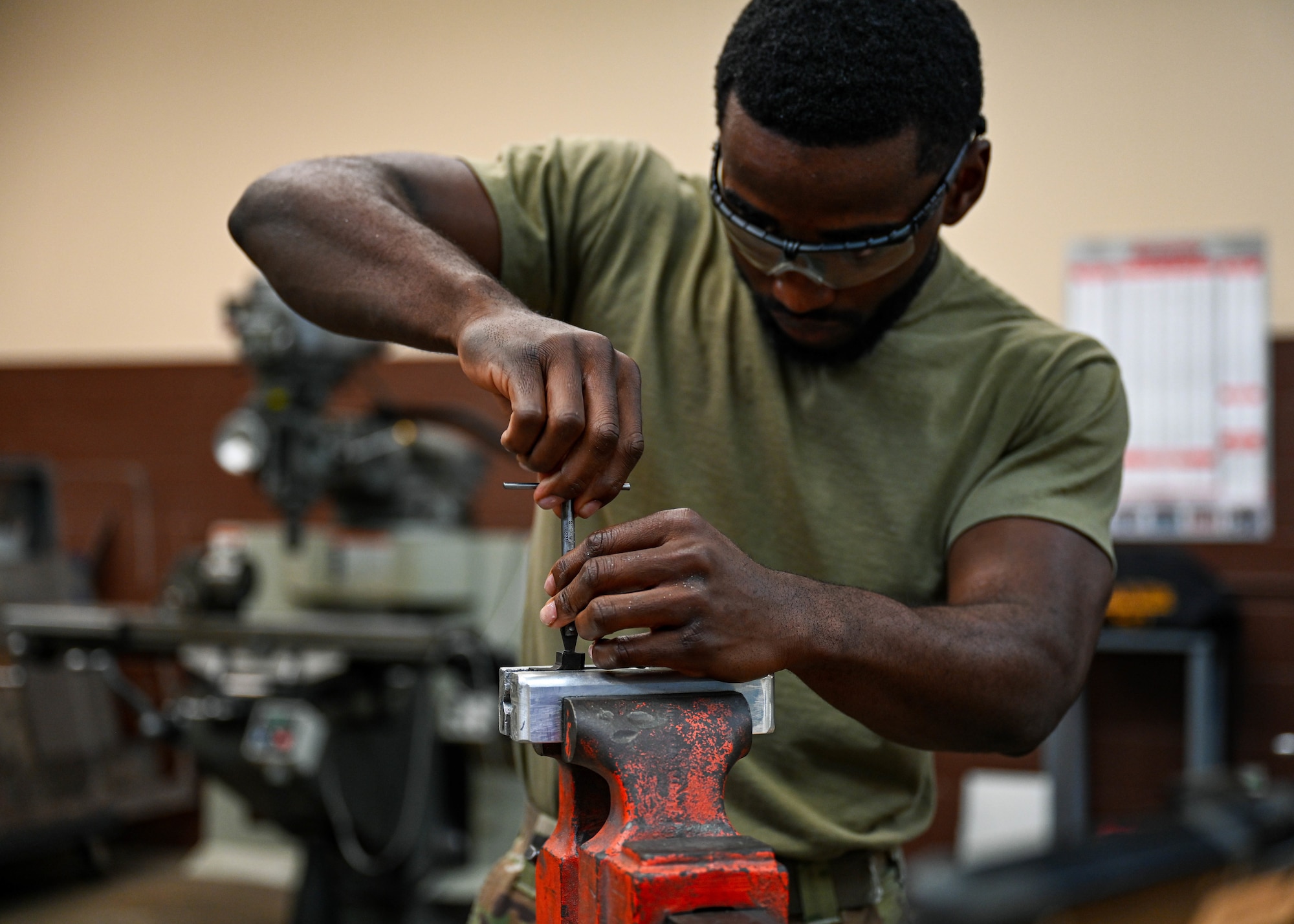 Airman 1st Class Nyamsi Ael, 15th Maintenance Squadron aircraft metals technology journeyman, utilizes a thread repair tool on wind-shield level for a C-17 Globemaster III at Joint Base Pearl Harbor-Hickam, Hawaii, July 31, 2023. The 15th MXS metals technology Airmen are trained to manipulate metal with a variety of machinery to increase the longevity of the transportation airframes stationed at Hickam. (U.S. Air Force photo by Senior Airman Zoie Cox)