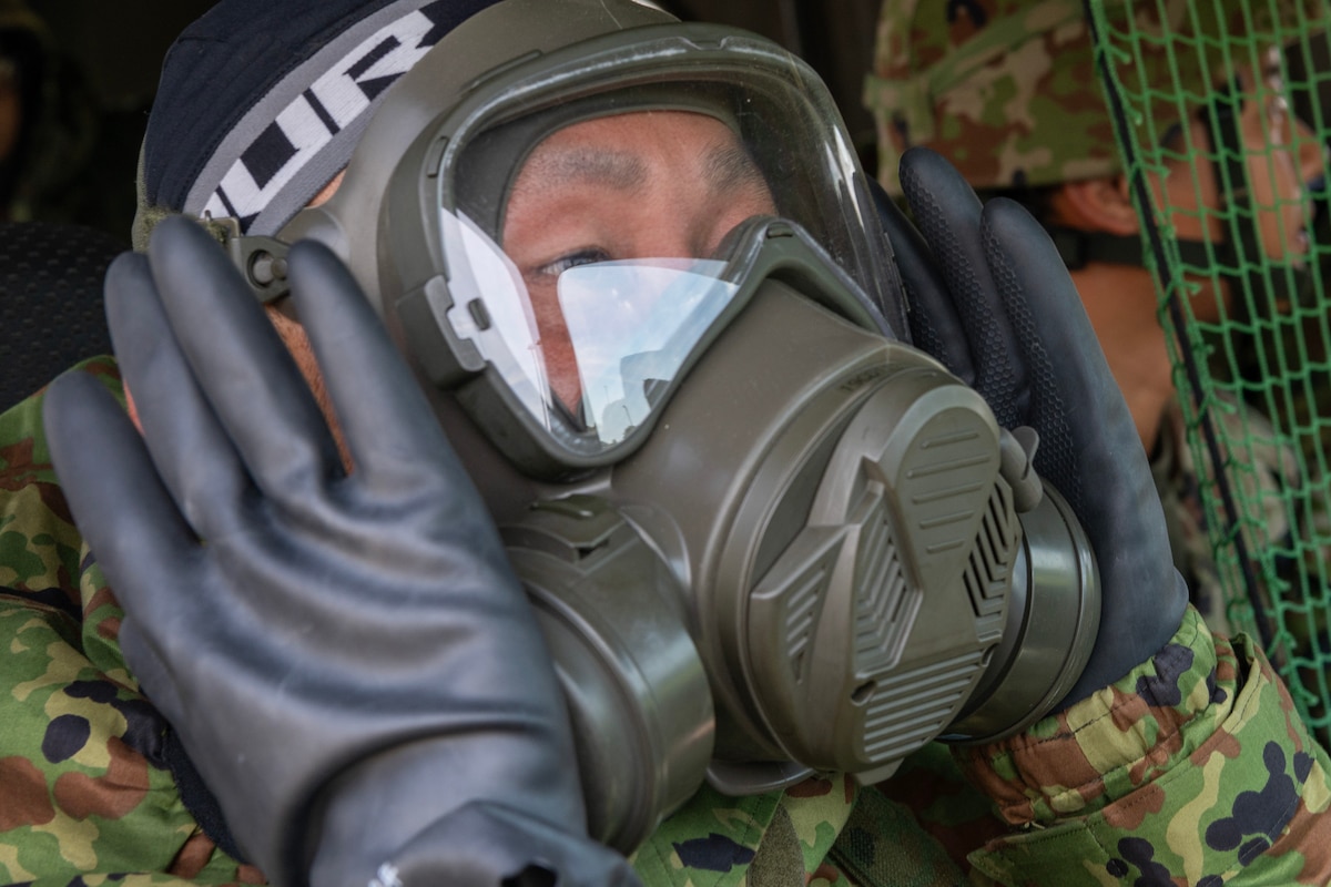 A Japan Ground Self-Defense Force (JGSDF) Soldier assigned to the 34th Infantry Regiment dons mission-oriented protective posture (MOPP) gear in a high-mobility vehicle during a training course on how to drive while in MOPP4 at Yokota Air Base, Japan, Aug. 30, 2023. JGSDF soldiers trained how to drive under Chemical, Biological, Radiological, Nuclear and Environmental conditions with Airmen assigned to the 374th Security Forces Squadron. (U.S. Air Force photo by Yasuo Osakabe)