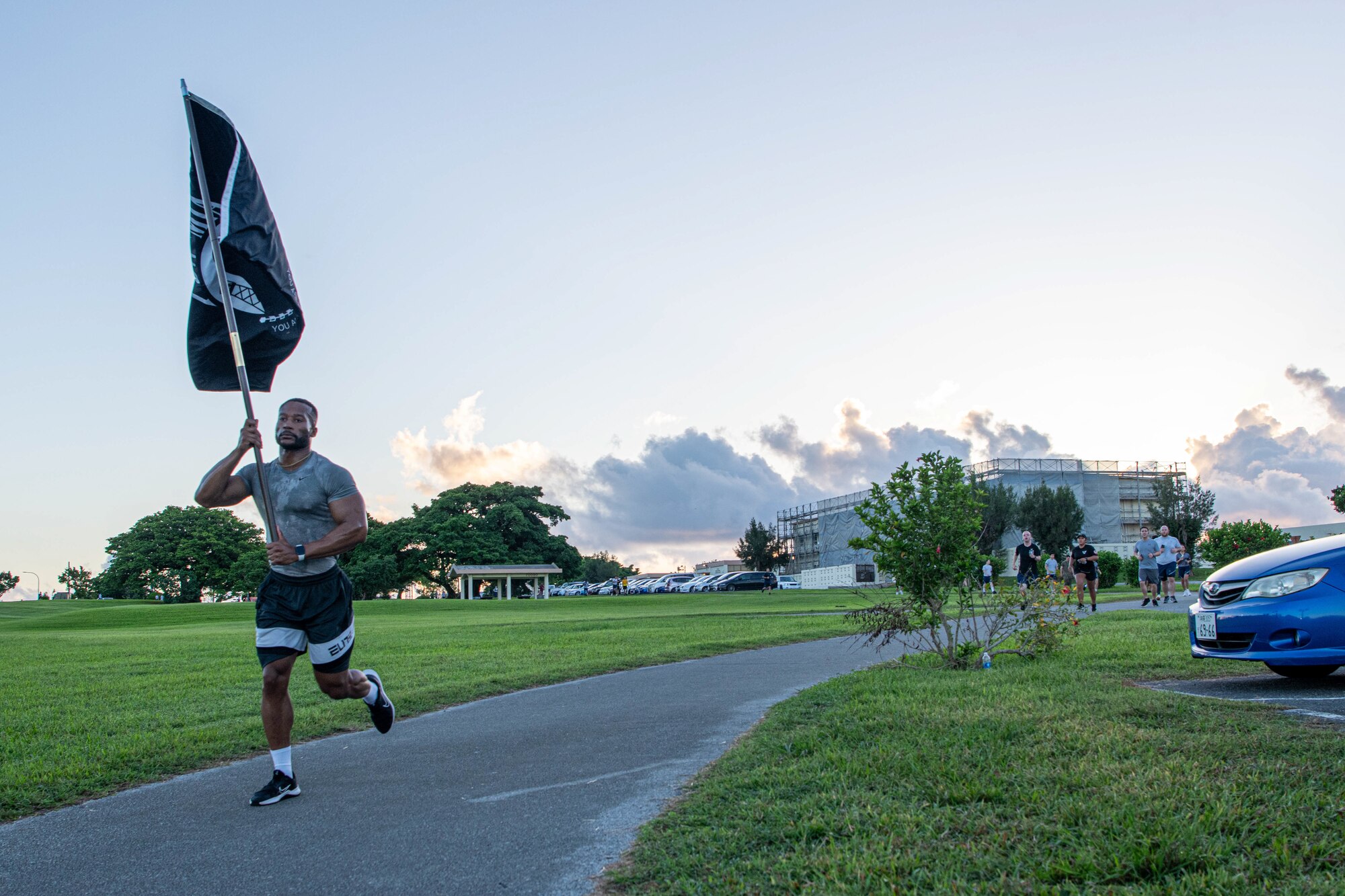 A service member carries the POW/MIA flag during the 24-Hour Remembrance Run.