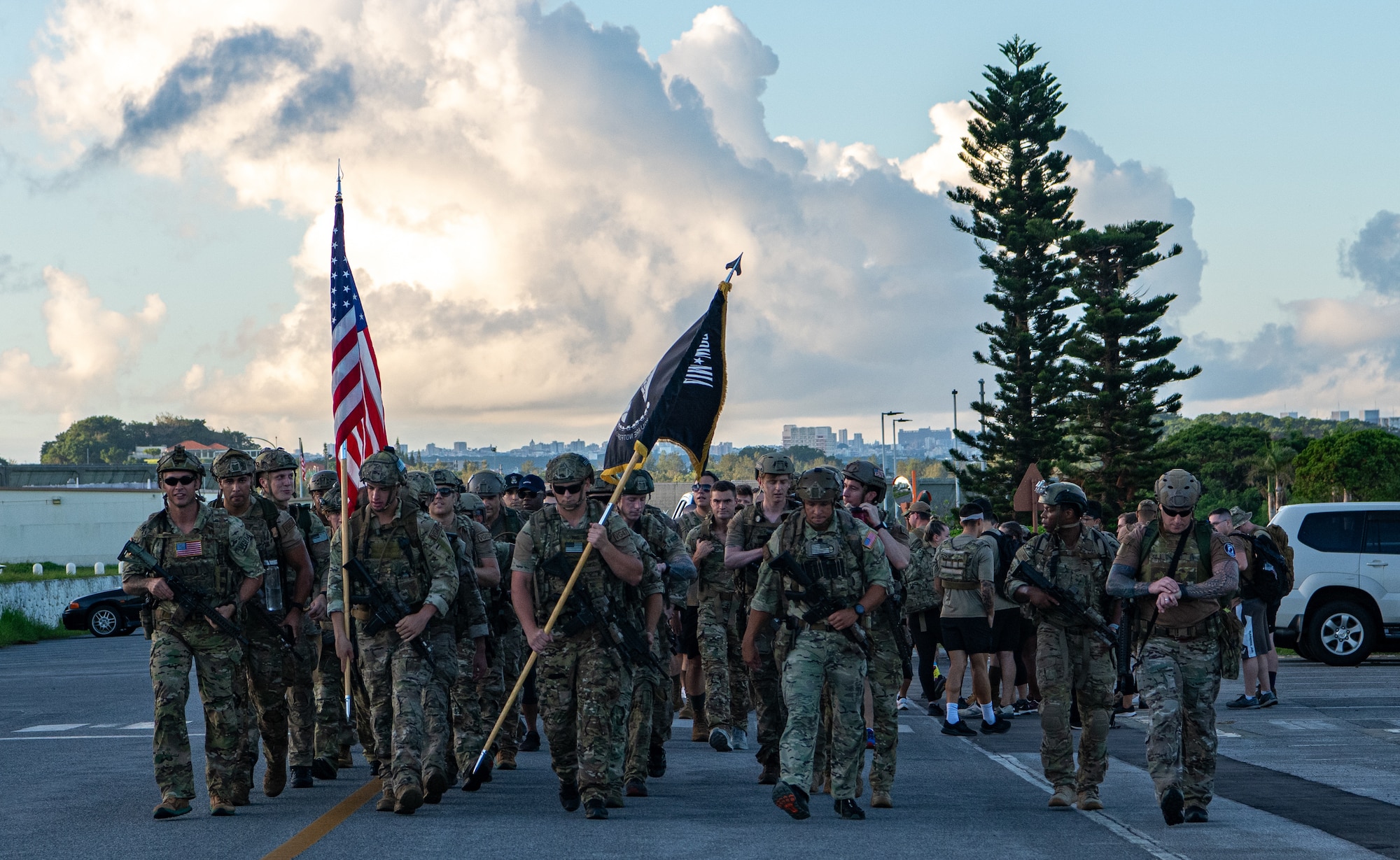 I group of service members begin a ruck march.