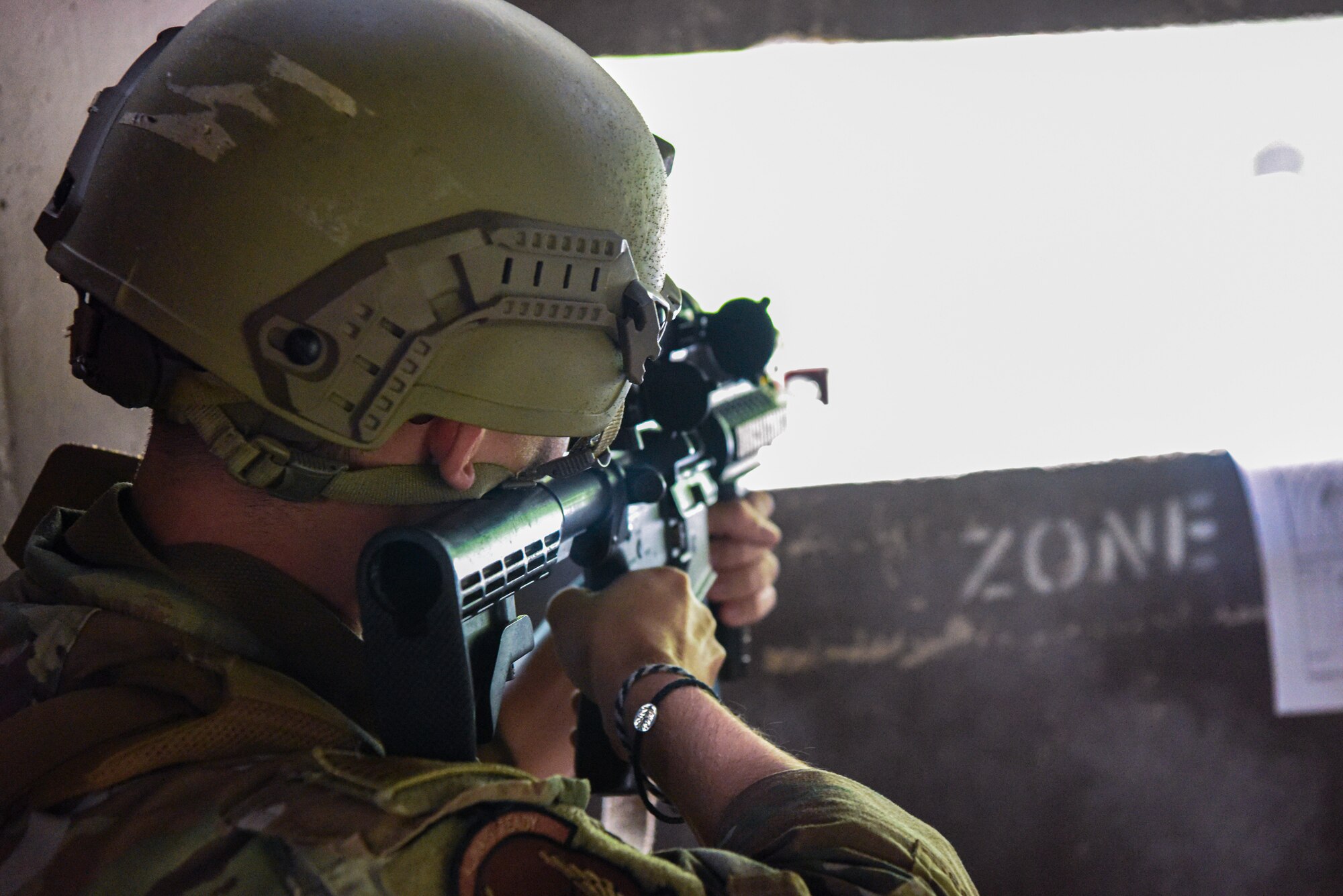U.S. Air Force Airman 1st Class Dimitri Yetzke, 51st Security Forces Squadron Defender, returns fire at opposing forces during a simulated attack at Osan Air Base, Republic of Korea, Sept. 21, 2023. Multi-capable Airmen from various career fields are augmented as security forces to respond to contingencies. Training with augmentees allows Defenders to refine their tactics and guide their response to potential threats. (U.S. Air Force photo by Airman 1st Class Chase Verzaal)