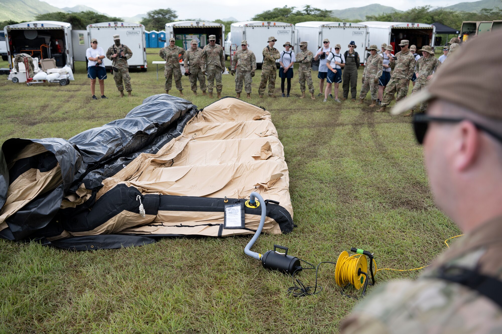 U.S. Airmen assigned to the Kentucky Air National Guard's 123rd Medical Group, Detachment 1, assemble an inflatable tent during a collective training exercise at Camp Santiago Joint Training Center, Salinas, Puerto Rico, Aug. 10, 2023. The exercise allowed service members assigned to the 156th Medical Group, 123rd Medical Group and the Puerto Rico Army National Guard to exchange knowledge and implement the National Guard CBRN Response Enterprise Information Management System, which assists with accelerating data collection from search and extraction teams in emergency events. (U.S. Air National Guard photo by Master Sgt. Rafael D. Rosa)