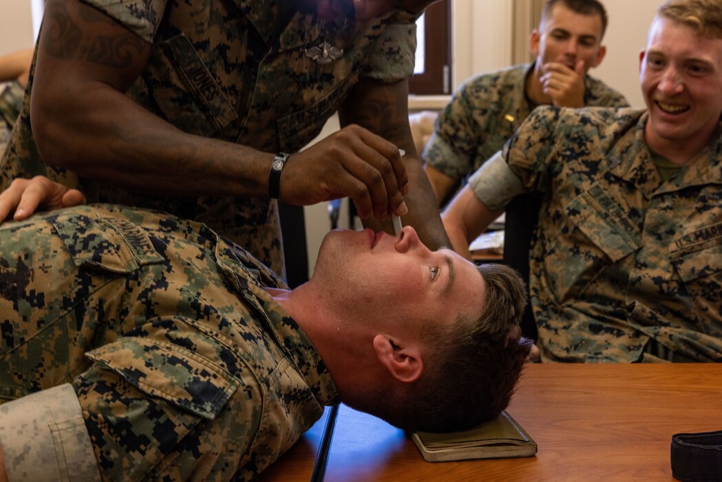 A U.S. Navy Hospital Corpsman, inserts a Nasopharyngeal into a U.S. Marine, attached to USS Hershel “Woody” Williams, during a Tactical Combat Casualty Care training. The purpose of TCCC is to increase survivability through life saving skills and get Marines to a higher echelon of care. (U.S. Marine Corps Photo by Sgt. Nathan Mitchell)