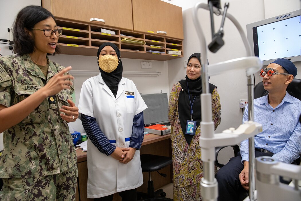 KUANTAN, Malaysia (Sept. 11, 2023) – Lt. Cmdr. Serena Leung (right), a Pacific Partnership 2023 optometrist, and Department of Optometry and Visual Science, Kulliyyah of Allied Health Sciences, International Islamic University Malaysia staff talk with a patient during Pacific Partnership 2023, Sept. 11.  Now in its 18th year, Pacific Partnership is the largest annual multinational humanitarian assistance and disaster relief preparedness mission conducted in the Indo-Pacific. (U.S. Navy photo by Chief Mass Communication Specialist Eric Chan)