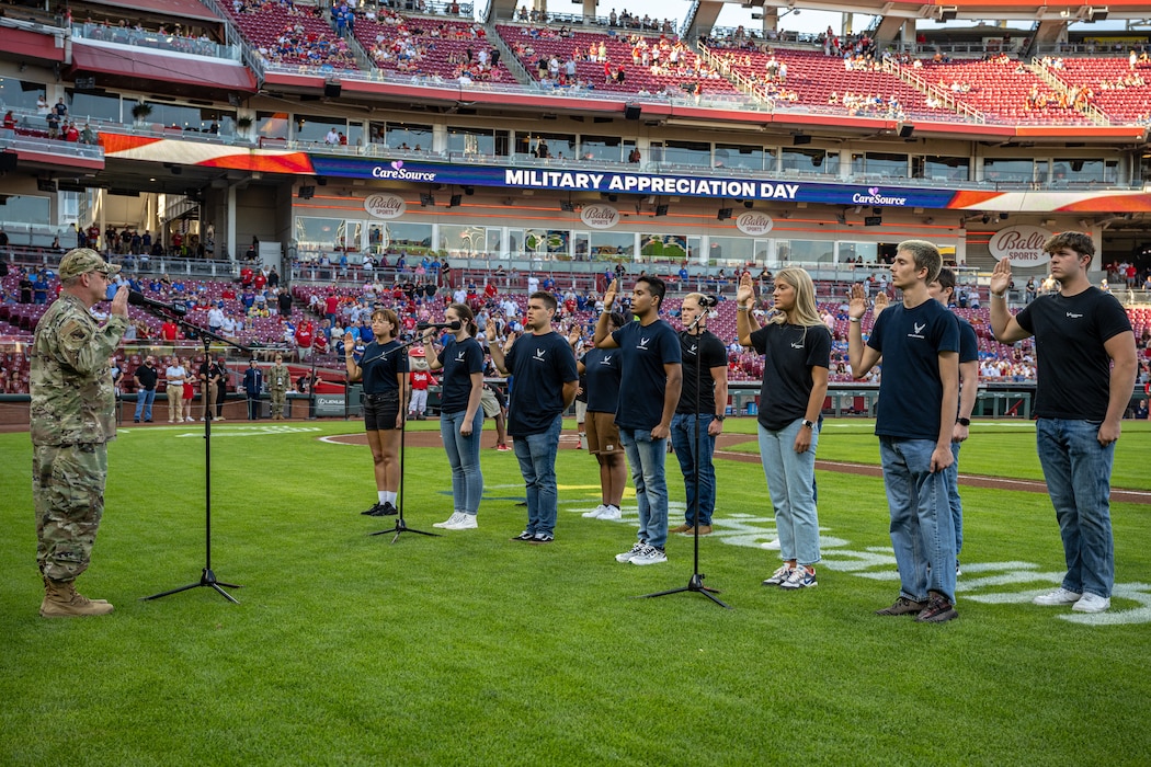 Col. Meeker administers the oath of enlistment to a group of Air Force recruits