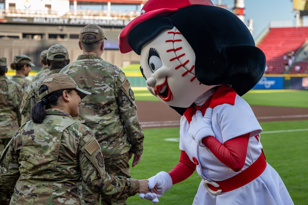 Reds' mascot shakes a service members hand