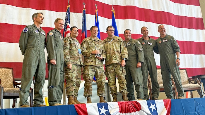 airmen standing on stage