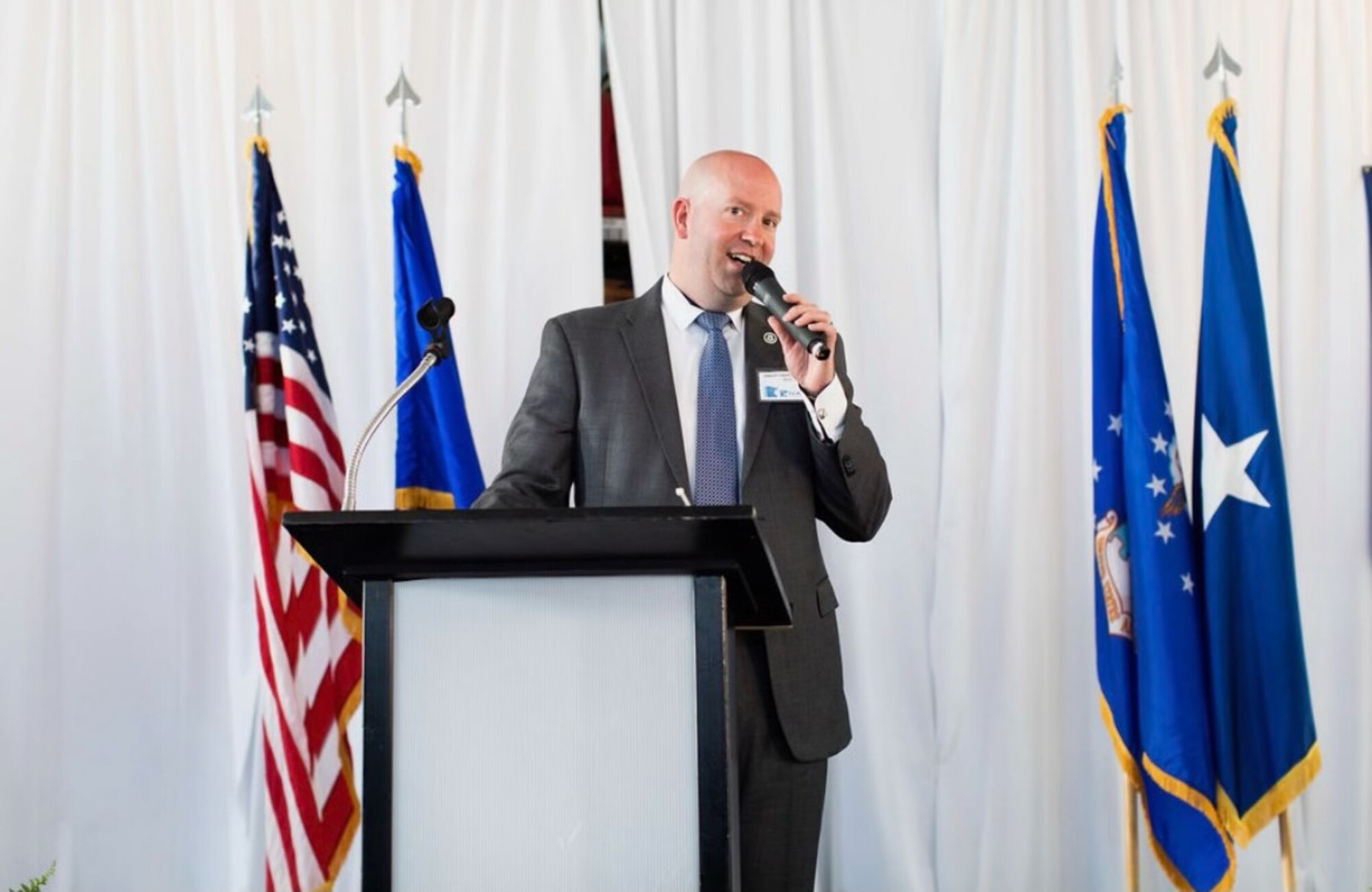 Special Agent (Major) Jason VanOverbeke, Individual Mobilized Augmentee to the Air Force Office of Special Investigations, Investigations, Collections and Operations Nexus (ICON) Center, speaks during heritage dinner hosted by his organization, May 14, 2022. Vanoverbeke serves as the Board President of the Twin Cities Area United States Air Force Academy Association Graduates. The heritage dinner is one of many events he and his team put together to support veterans in his local community. (Courtesy photo)