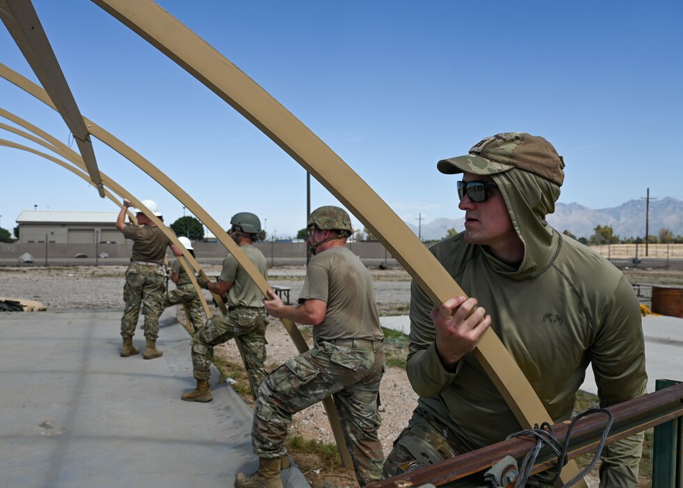 Airmen assigned to the 355th Civil Engineer Squadron disassemble an Alaska Small Shelter System