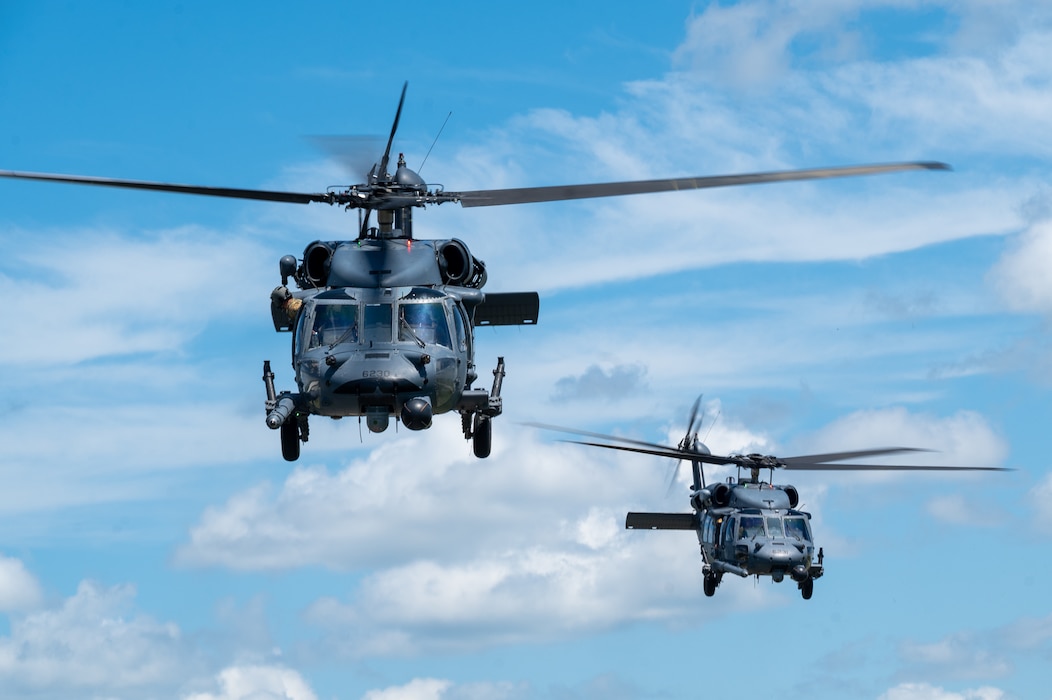Two HH-60G Pave Hawks fly overhead