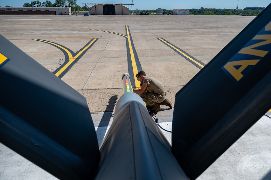 Pennsylvania Air National Guardsman Senior Airman Matthew Bracall, a crew chief assigned to the 171st Air Refueling Wing, services surge boots on a KC-135 Stratotanker