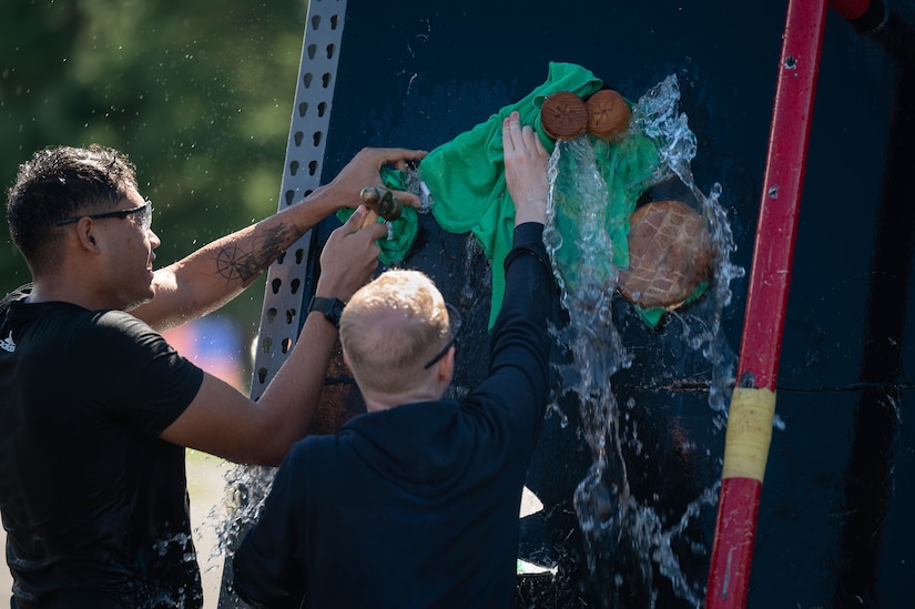 Service members work to stop a leak on a simulated vessel during a U.S. Coast Guard Atlantic Strike Team training exercise at Joint Base McGuire-Dix-Lakehurst, N.J., Sept. 15, 2023. The Atlantic Strike Team is one of three global strike teams made by Congress during the Clean Water Act of 1972. (U.S. Air Force photo by Airman 1st Class Aidan Thompson)