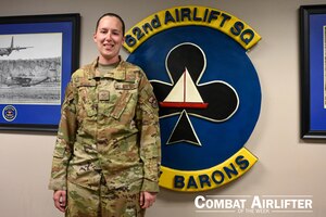 A woman in uniform poses for a photo