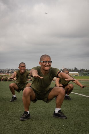 U.S. Marine Corps recruits with Kilo Company, 3rd Recruit Training Battalion, execute air squats during a physical training session at Marine Corps Recruit Depot San Diego, Sept. 19, 2023. Physical training challenges recruits to strengthen themselves physically and mentally. (U.S. Marine Corps photo by Lance Cpl. Janell B. Alvarez)