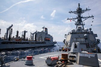 USS Ralph Johnson (DDG 114) replenishes from USNS Yukon (T-AO-202) in the South China Sea.