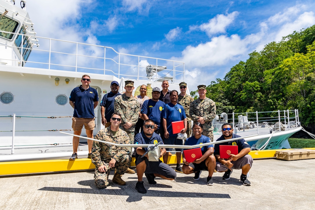 U.S. Marines with Task Force Koa Moana 23 and Palauan Maritime Law Enforcement Officers pose for a photograph at the conclusion of the Task Force Koa Moana RQ-20B Puma Training Course graduation at the Palau Joint Operations Center, Bureau of Maritime Security and Fish & Wildlife Protection, Koror, Palau, Sept. 14, 2023. Task Force Koa Moana 23, composed of U.S. Marines and Sailors from I Marine Expeditionary Force, deployed to the Indo-Pacific to strengthen relationships with Pacific Island partners through bilateral and multilateral security cooperation and community engagements. (U.S. Marine Corps photo by Staff Sgt. Courtney G. White)