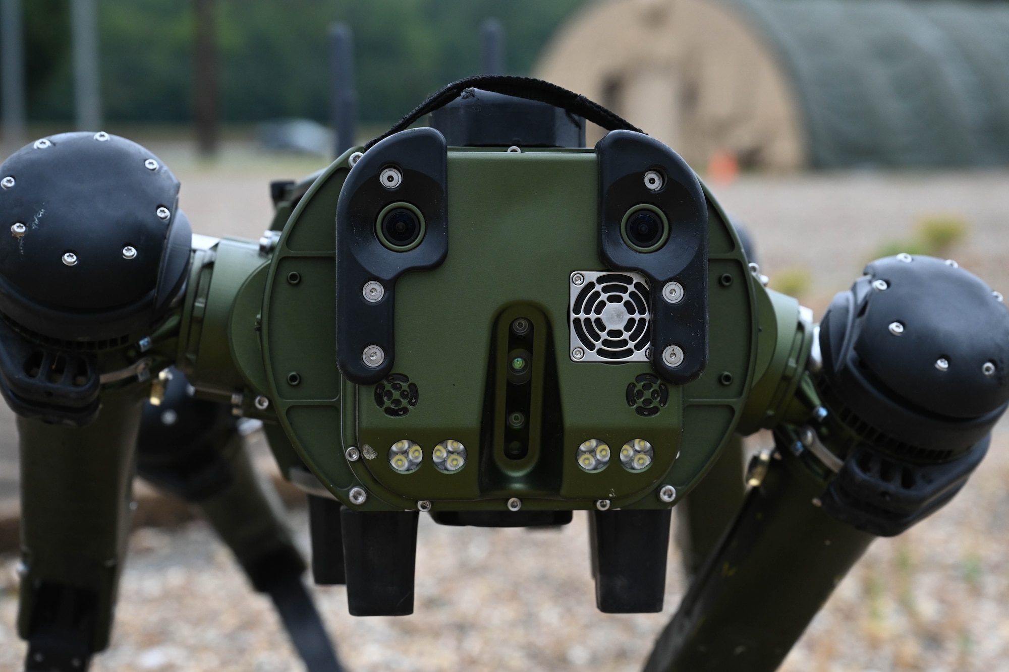 Atom, the robot dog, shows off its dog-like face at Barksdale Air Force Base, Louisiana, on September 13, 2023. Two front cameras allow Atom to have eyes, along with cameras built into both sides and the back of the robot dog for a 360 degree look into its surroundings. (U.S. Air Force photo by Airman Rhea Beil)

