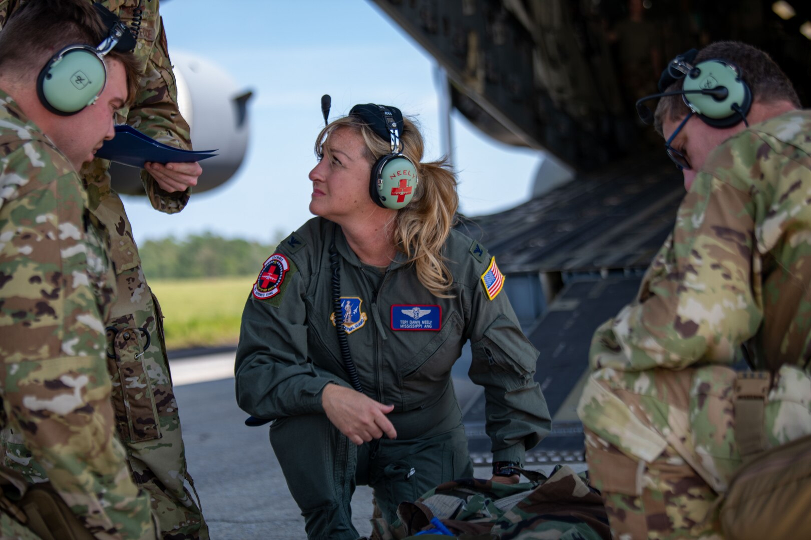 Col. Teri Neely, commander of the 183rd Aeromedical Evacuation Squadron, Jackson, Mississippi, receives the status of a simulated patient during Operation Iron Magnolia at Camp Shelby Joint Forces Training Center Auxiliary Airfield, Hattiesburg, Mississippi, Sept. 9, 2023.