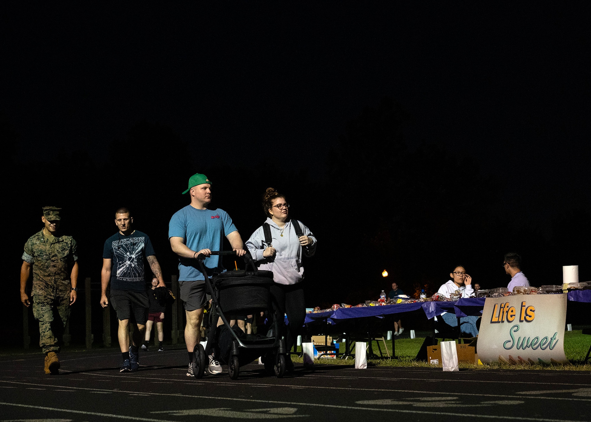 Fort George G. Meade community members participate in the 7th Annual Illuminating the Darkness event on September 21, 2023, at Fort Meade, Maryland. The 70th Intelligence, Surveillance and Reconnaissance Wing teamed up with the Cryptologic Warfare Group SIX in support of Suicide Prevention month to honor the memories of victims and to recognize the power everyone possesses to help one another. The event included an overnight walk, games, and interactive and informational booths. (U.S. Air Force photo by Tech. Sgt. Kevin Iinuma)