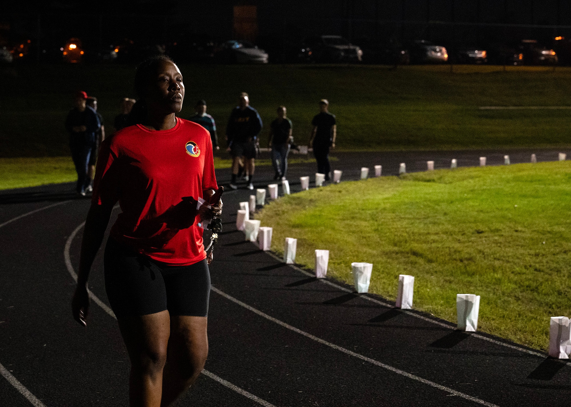 U.S. Air Force Senior Master Sgt. Lakisha DeJesus, 707th Communications Squadron operations superintendent, walks during the 7th Annual Illuminating the Darkness event Sept. 21, 2023, at Fort Meade, Maryland. The 70th Intelligence, Surveillance and Reconnaissance Wing teamed up with the Cryptologic Warfare Group SIX in support of Suicide Prevention month to honor the memories of victims and to recognize the power everyone possesses to help one another. The event included an overnight walk, games, and interactive and informational booths. (U.S. Air Force photo by Tech. Sgt. Kevin Iinuma)