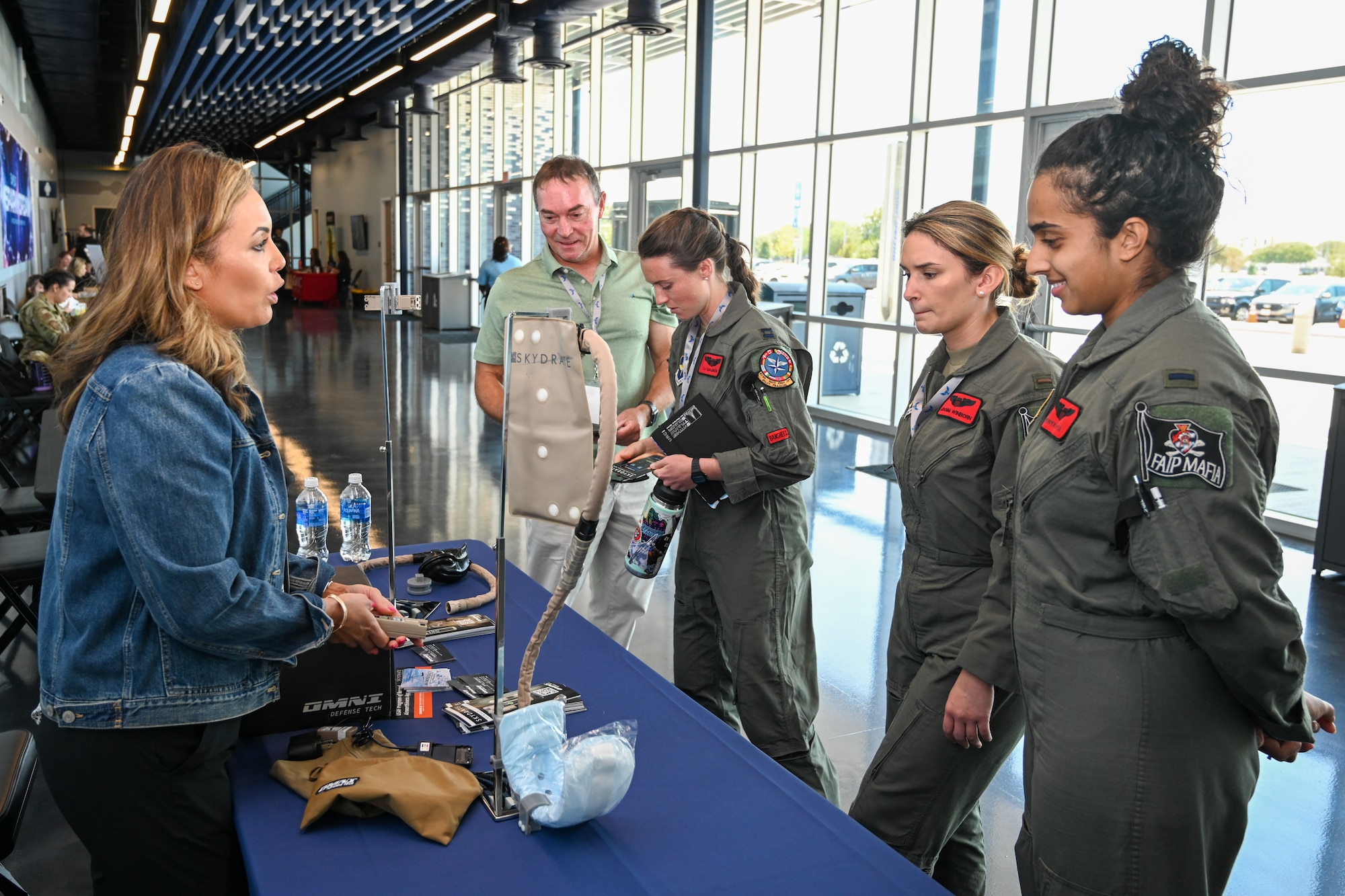 Airmen from wings across Air Education and Training Command speak with a vendor about new technology and equipment for women in the military during the Torch Athena Rally and Fly-In, San Antonio, Texas, Sept. 19, 2023. The three-day event aims to leverage education to enact change and inspire diverse female warfighter Airmen of the future. (U.S. Air Force photo by Thomas Coney)