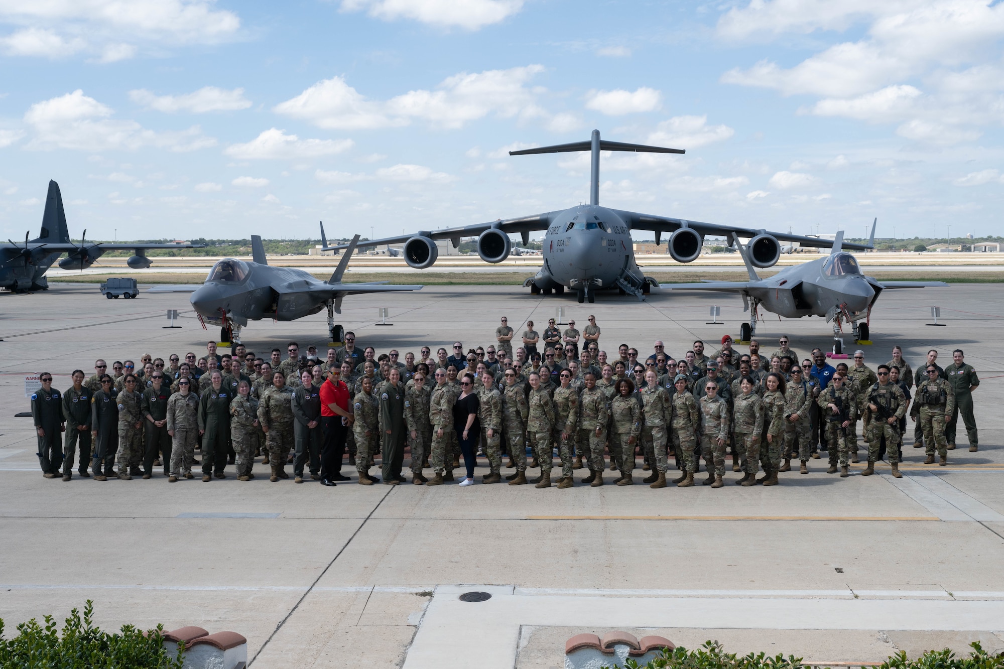 Members across the Air Education and Training command who helped coordinate and execute Girls in Aviation celebration pose for a group photo, Kelly Field, Joint Base San Antonio-Lackland, Texas, Sept. 21, 2023. About 400 local students attended the Girls in Aviation celebration, which showcased women from across Air Education and Training Command and their aircraft. The women represented various career fields, such as pilots, maintainers and boom operators. (U.S. Air Force photo by Airman 1st Class Gabriel Jones)