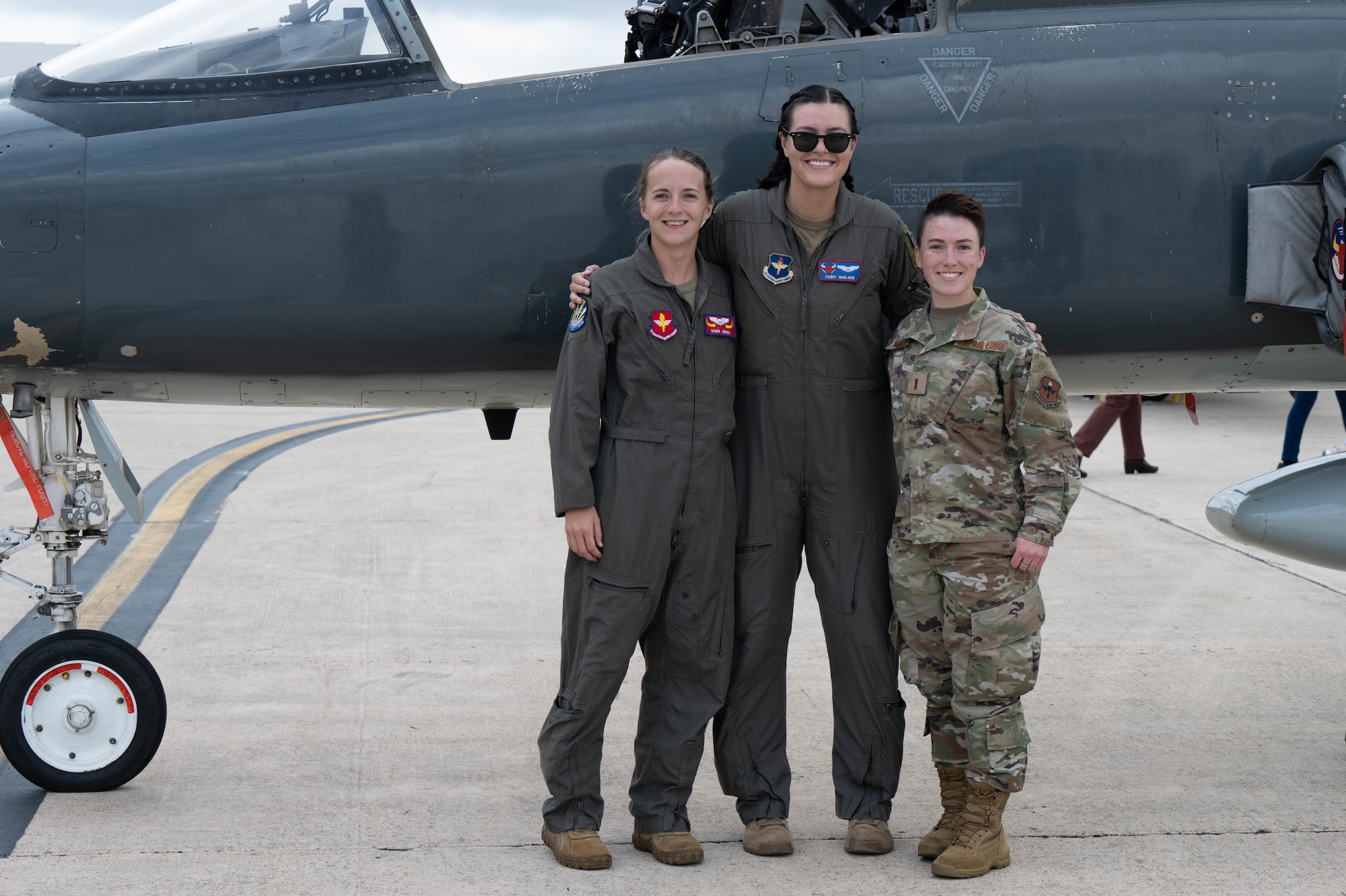 U.S. Air Force T-38 Talon instructor pilots 1st Lt. Kaylee Eskeli and Capt. Cassandra McElwee, 87th Flying Training Squadron, and 2nd Lt. Brittany Stanley, a pilot-awaiting-training assigned to 306th Operations Support Squadron, pose for a photo during Girls in Aviation celebration at Kelly Field, Joint Base San Antonio-Lackland, Texas, Sept. 21, 2023. About 400 local students attended the event, which showcased women from across Air Education and Training Command and their aircraft. The women represented various career fields, such as pilots, maintainers and boom operators. (U.S. Air Force photo by Airman 1st Class Gabriel Jones)