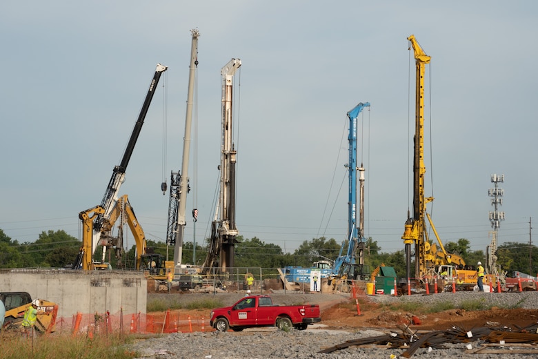 Photo shows multiple drill rigs working on the construction site.