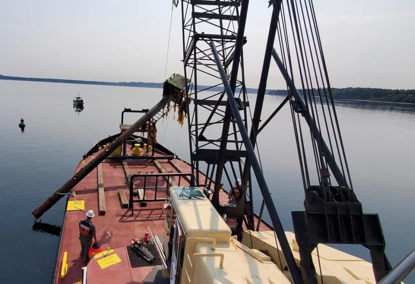 Debris recovery vessel snags and removes navigational hazards near Whidbey Island, Washington.